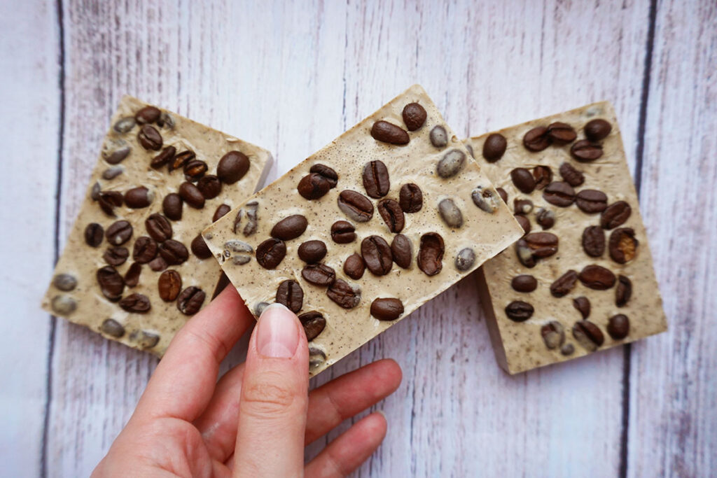 hand holding a coffee oatmeal soap bar.