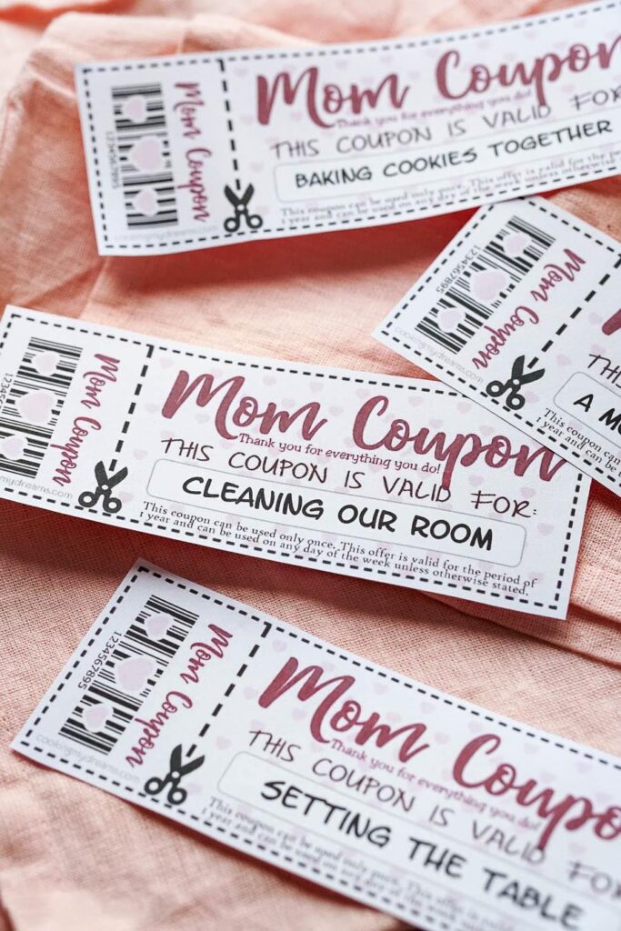 mom coupons scattered on a pink cloth.