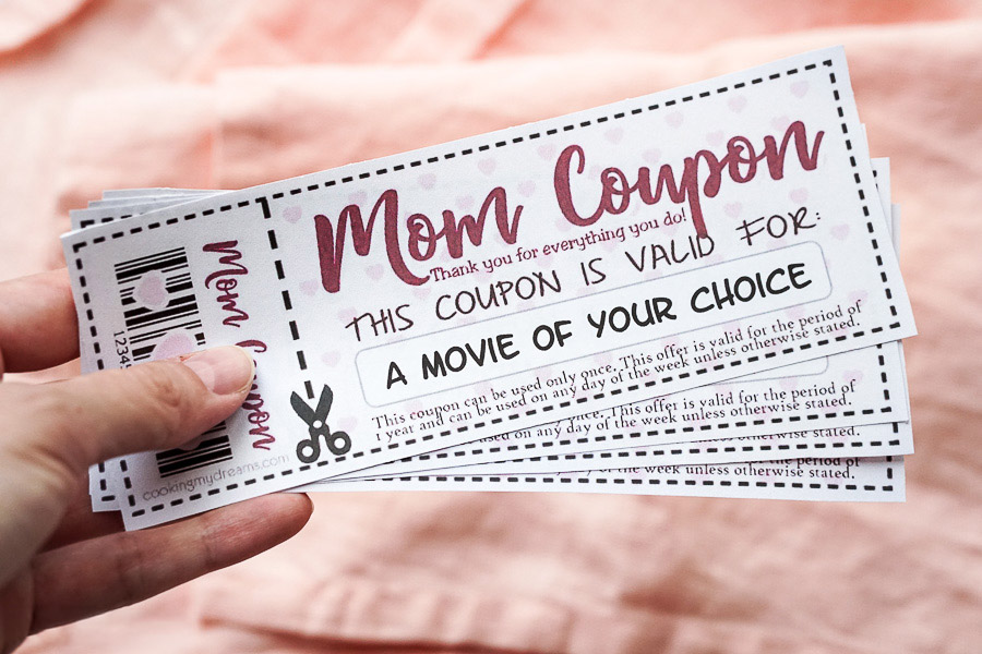 hand holding mom coupons.