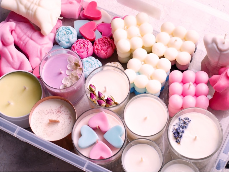 Box of colorful handmade candles.